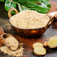 Load image into Gallery viewer, bowl of ginger powder with fresh sliced ginger on table