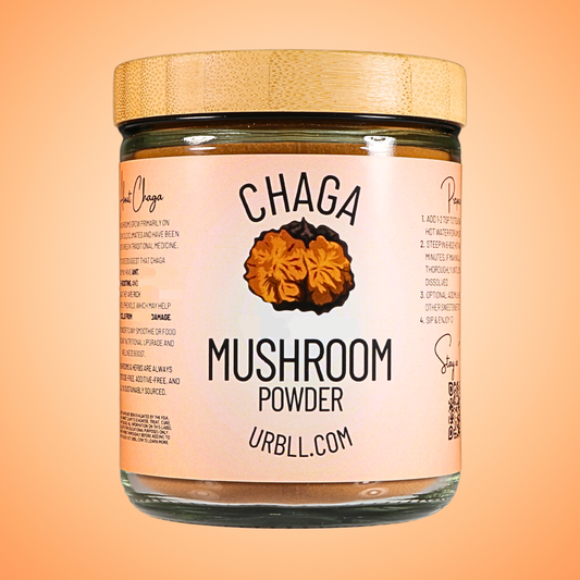 Jar of Chaga mushroom powder with a wooden lid on an orange background