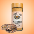 Load image into Gallery viewer, Jar of turkey tail mushroom powder with a label on an orange background
