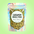 Load image into Gallery viewer, Packaged cardamom whole pods with a colorful label on a green background
