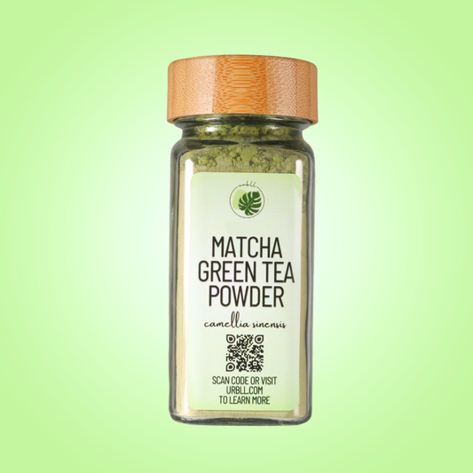 Jar of matcha green tea powder with a wooden lid on a green background