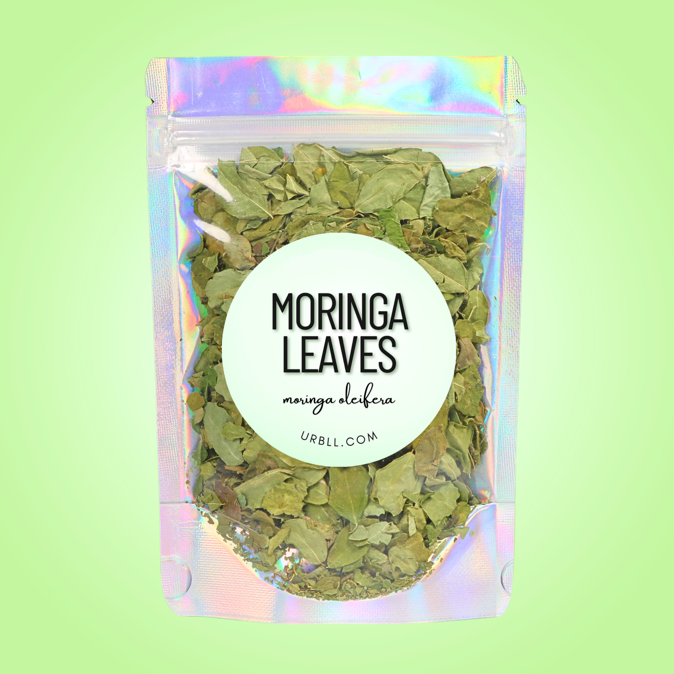 Packaged moringa leaves with a colorful holographic sleeve on a light green background